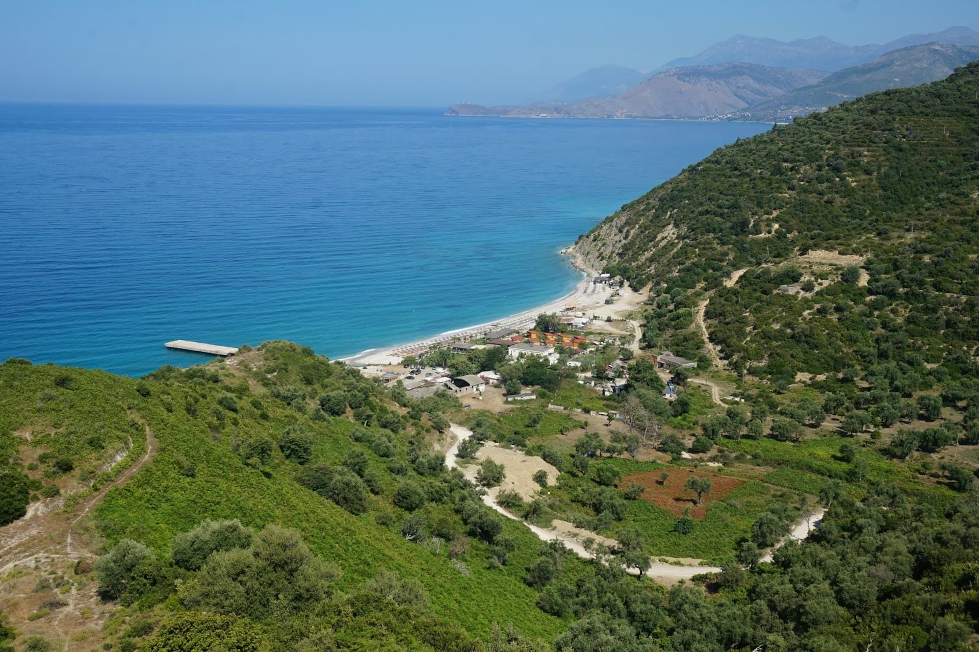 The Albanian Riviera coastline — a clear-water cove where the mountains meet the Ionian Sea